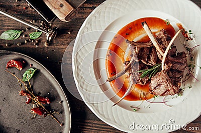 Mutton ribs dish top view composotion with red sauce at dark wooden background Stock Photo