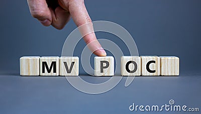 MVP vs POC symbol. Businessman pushes the cube with words MVP, minimum viable product and POC, proof of concept. Beautiful grey Stock Photo