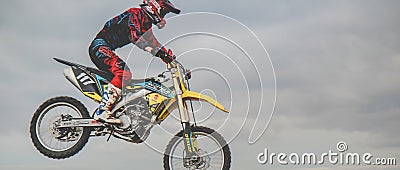 MX moto cross racing - Girl Bike Rider riding on dirt track - extreme jump. Extreme Motocross . Editorial Stock Photo