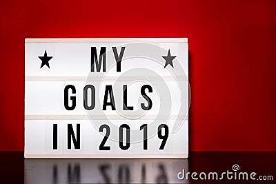 My goals 2019 sign - cinema style lettering on light box & warm red background Stock Photo