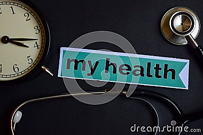 My Health on the print paper with Healthcare Concept Inspiration. alarm clock, Black stethoscope. Stock Photo