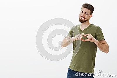 My love is yours. Portrait of charming charismatic caucasian boyfriend with beard in t-shirt smiling broadly showing Stock Photo
