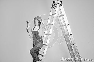 This is my place. worker engineer. architect in workshop. renovation and repair. teen girl in helmet and boilersuit on Stock Photo