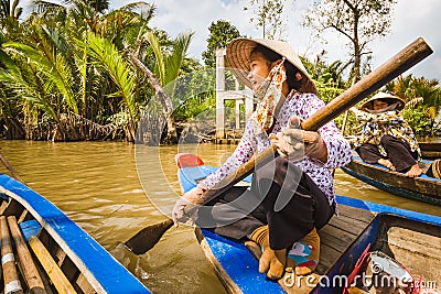 Women rowing a boat at the Mekong river Editorial Stock Photo