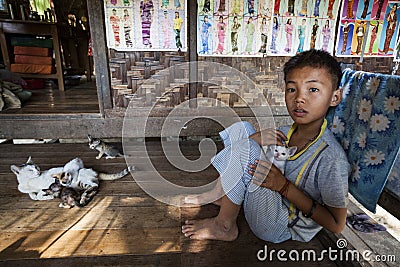 Myanmar - cat and child inside a tradicional home Editorial Stock Photo