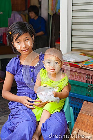 Myanmar Travel Images teenage girl and her small sister both with traditional thanaka on their faces Editorial Stock Photo