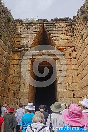 Mycenae, Greece: Tourists visit the Treasury of Atreus, or Tomb of Agamemnon Editorial Stock Photo