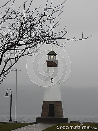 Myers Park lighthouse shines in winter lake fog Stock Photo