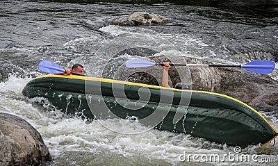 Myhiya / Ukraine - August 24 2018: Kayakers fights the white water in a Pivdenny Bug river. They and their kayak are flipping over Editorial Stock Photo