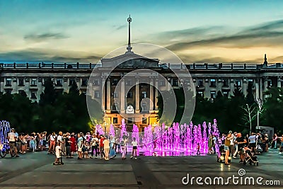 Glowing purple pedestrian fountain on the square near the Mykolaiv City Council Editorial Stock Photo