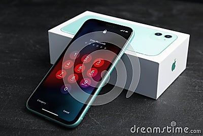 MYKOLAIV, UKRAINE - JULY 10, 2020: New modern Iphone 11 with numpad for entering passcode near box Editorial Stock Photo