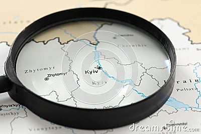 MYKOLAIV, UKRAINE - NOVEMBER 09, 2020: Kyiv city marked on map of Ukraine, view through magnifying glass Stock Photo