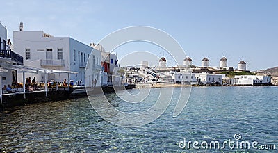 View of the famous windmills of Mykonos island from Little Venice restaurant Editorial Stock Photo