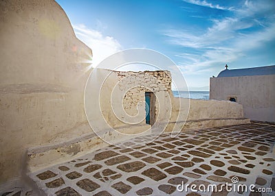 Mykonos streetview with sun and blue sky, Greece Stock Photo