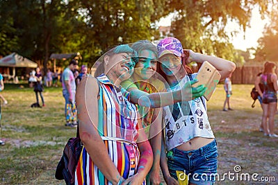 Myrhorod, Ukraine - June 16, 2019: Family taking selfie after throwing paints on indian Holi festival of colors Editorial Stock Photo