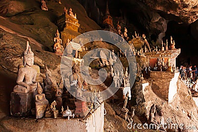 Myriad ancient Buddha statues in Pak Ou Caves Stock Photo