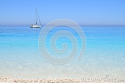 Myrthos Beach, crystal clear waters and the ship with sails Stock Photo