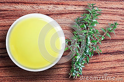 Myrtle oil in a ceramic bowl, green branches of myrtle, a medici Stock Photo