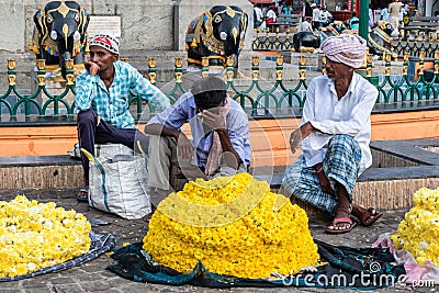 Indian flower vendors at their shop selling flowers at the Devaraja market in the city of Editorial Stock Photo