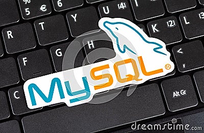 MySQL logo sticker laying on a laptop keyboard, object closeup, nobody. My SQL database technology symbol, website backend Editorial Stock Photo