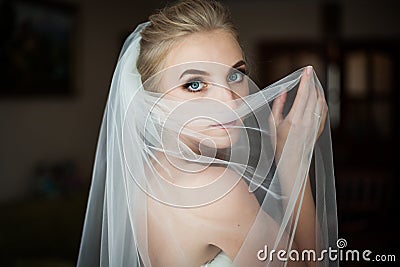 Mysterious beautiful blue eyes blonde bride hiding Stock Photo