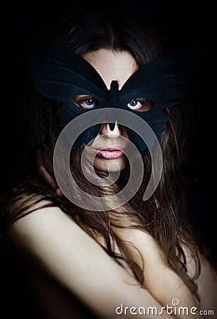 Mysterious beautiful girl in butterfly mask Stock Photo