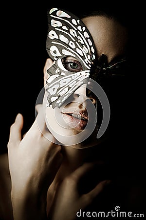 Mysterious beautiful girl in butterfly mask Stock Photo