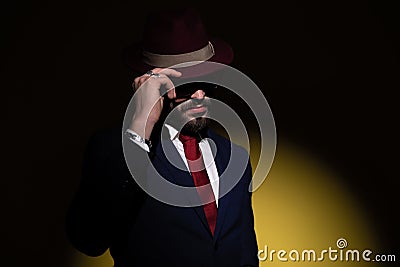 Mysterious businessman covering face with hat and posing Stock Photo