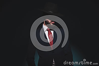 Mysterious businessman hidding his face under his hat Stock Photo