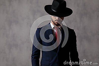 Mysterious businessman wearing a hat over his eyes Stock Photo