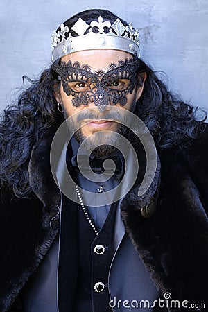 Mysterious elegant long haired man in masquerade Stock Photo