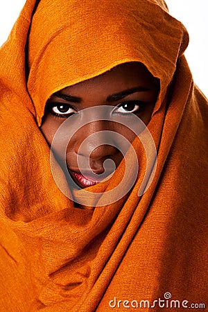 Mysterious female face in ocher head wrap Stock Photo