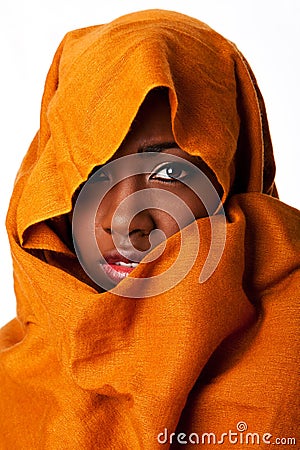 Mysterious female face in ocher head wrap Stock Photo