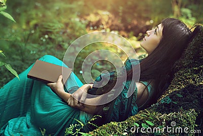 Mysterious image of a beautiful woman in woods. Lonely mysterious girl on background of wild nature. Woman in search of herself Stock Photo