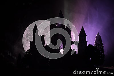 Mysterious medieval castle in a misty full moon. Abandoned gothic style old castle at night Stock Photo