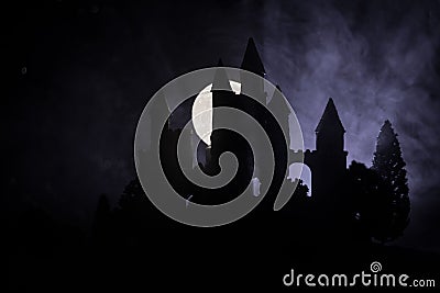 Mysterious medieval castle in a misty full moon. Abandoned gothic style old castle at night Stock Photo