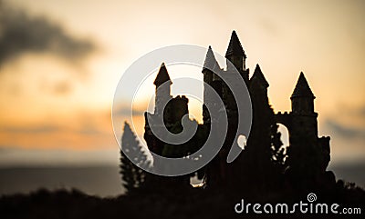 Mysterious medieval castle at sunset. Abandoned gothic style old castle at the evening Stock Photo