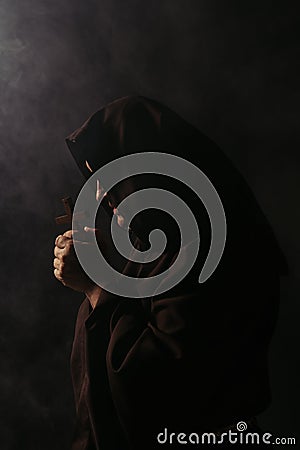 mysterious medieval monk in hooded robe Stock Photo