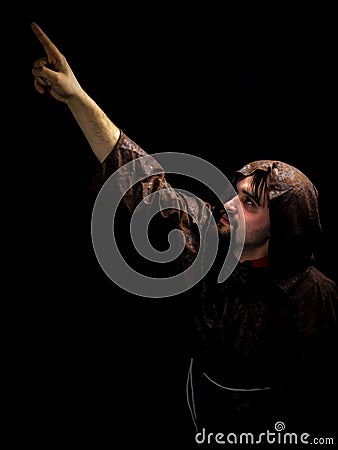 Mysterious monk on dark background. Stock Photo