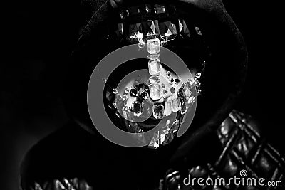 Mysterious mystical appearance of a man. Art portrait of a hooded man with big rhinestones on his face. Big crystals glisten in Stock Photo