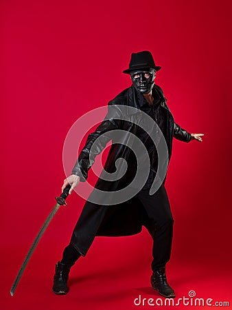 A mysterious ninja assassin in a noir style. A man in black clothes Stock Photo