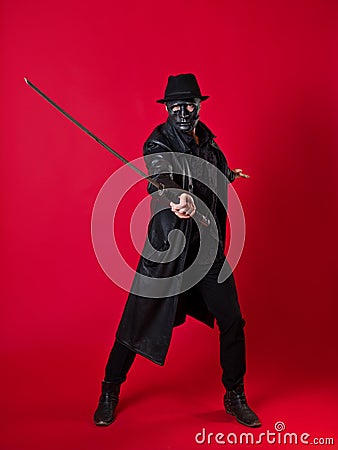 A mysterious ninja assassin in a noir style. A man in black clothes Stock Photo