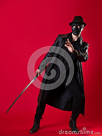 A mysterious ninja assassin in a noir style. A man in black leather clothes Stock Photo