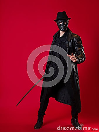 A mysterious ninja assassin in a noir style. A man in black leather clothes Stock Photo