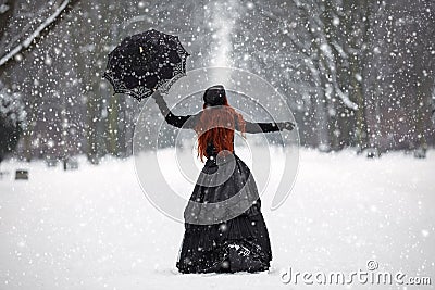 Mysterious red-haired woman in Victorian dress Stock Photo