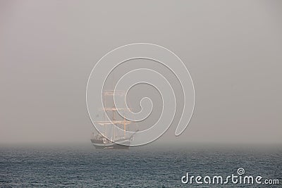 Mysterious sailing ship surrounded fog Stock Photo