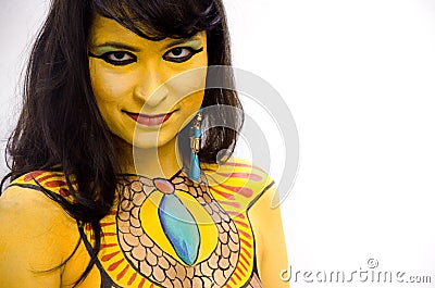 Mysterious yellow bodypainted tribal face of a girl on a white background. Stock Photo