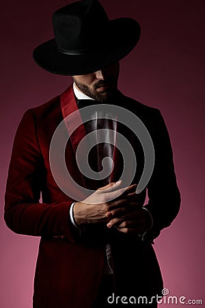 Mysterious young fashion man wearing red velvet tuxedo Stock Photo
