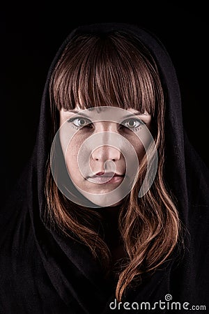 Mysterious young woman on black background Stock Photo