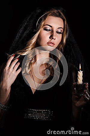 Mysterious young woman with a candle Stock Photo